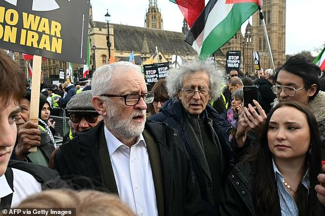 Jeremy Corbyn accuses Donald Trump of launching 'clearly illegal attack to bring about regime change' after joining hundreds of pro-Iran protesters in London carrying banners of the Ayatollah