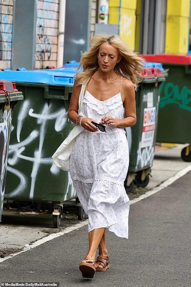 Comfort food! Jackie 'O' Henderson's daughter Kitty collects a takeaway delivery after a visit from best friend Gemma O'Neill amid radio show fallout