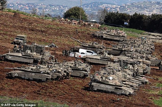 Israeli tanks continue to mass on Lebanese border as Israel flexes show of might as Netanyahu vows 'many surprises'