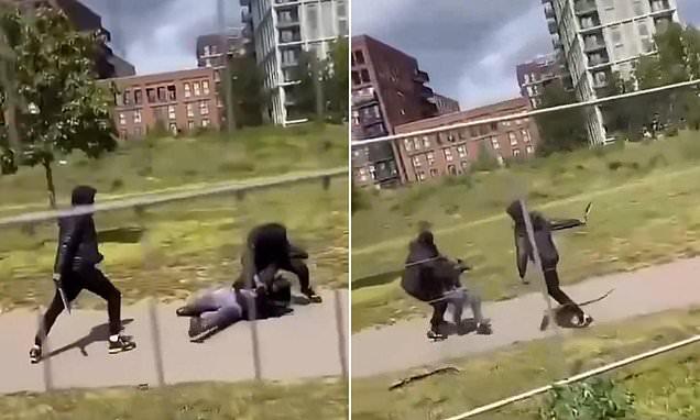 A brutal machete duel at Sunday lunchtime, another scene from Khan's 'safe' London: Video captures masked teens attacking each other with machetes in broad daylight in family park - as it emerges bystander jumped in to separate them