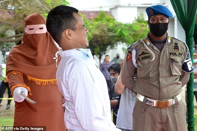 Inside Aceh's brutal public canings where gleeful crowds watch men and women being whipped until they pass out under Sharia law punishment for sex outside marriage and gambling