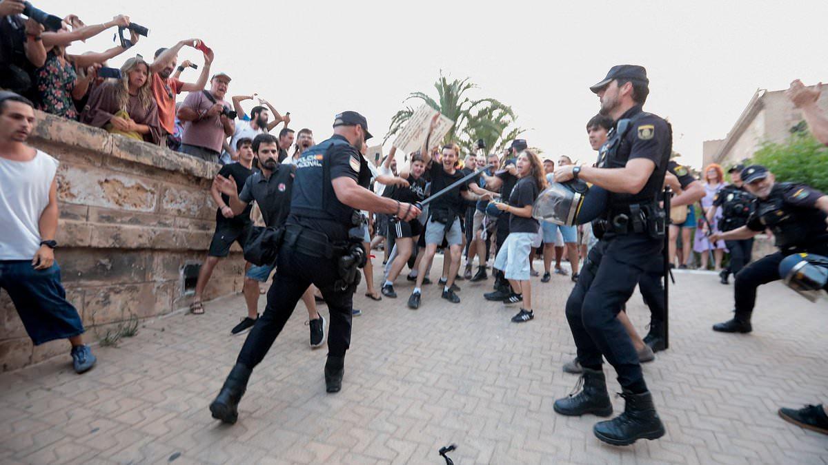 Armed riot police with shields clash with anti-tourism protesters in Mallorca as demonstrations turn violent