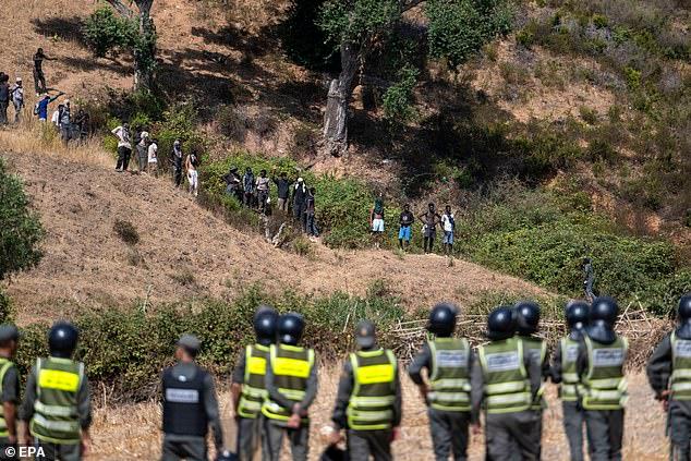 Riot police arrest nearly 300 migrants after thwarting second Ceuta 'invasion' as hundreds who gathered on hilltops were sprayed with tear gas