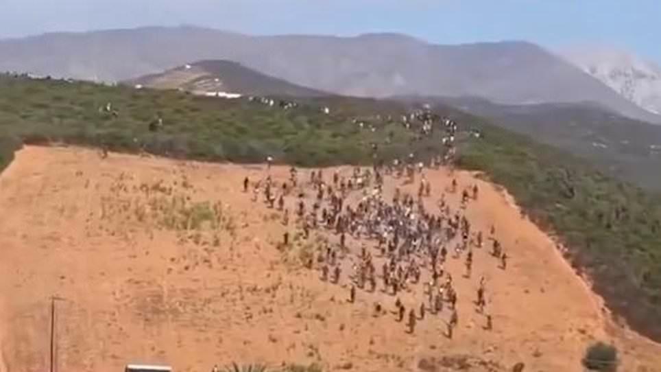 Moment hundreds of migrants try to storm Ceuta in second 'invasion' attempt before being beaten back and arrested by riot police