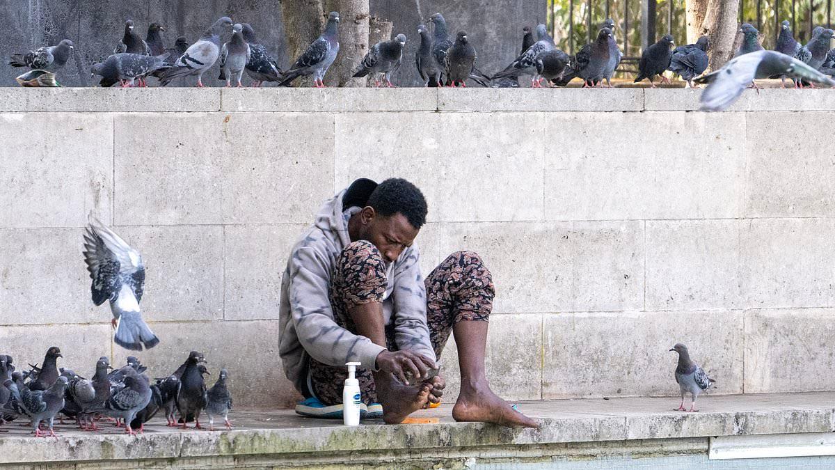 Rough sleeper washes his feet in Marble Arch fountain yards from high-end hotels as homeless camps take over London's most recognisable sights