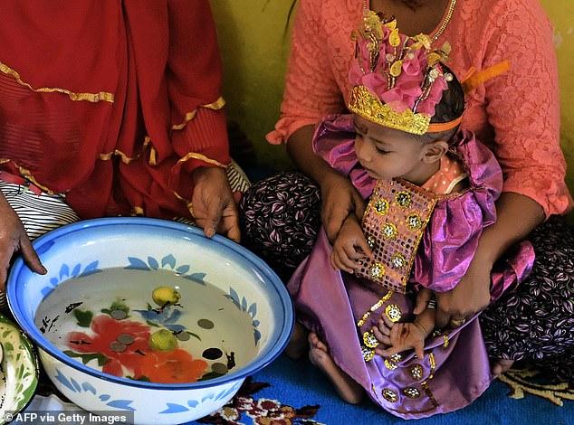 Inside Indonesia's brutal mass female circumcision ceremonies, where toddlers have genitals mutilated with knives