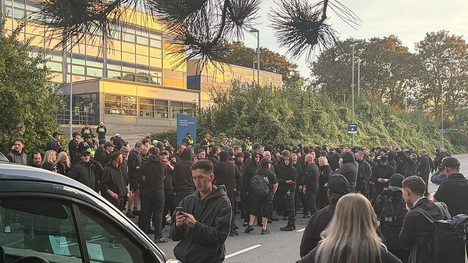 'Danny Tommo' is charged with criminal damage - as hundreds of black-clad supporters gather outside police station in protest at his arrest