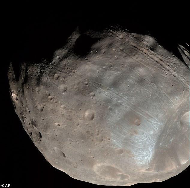 Mission to Mars! Japanese spacecraft begins epic five-year quest to bring Martian moon samples back to Earth for the first time