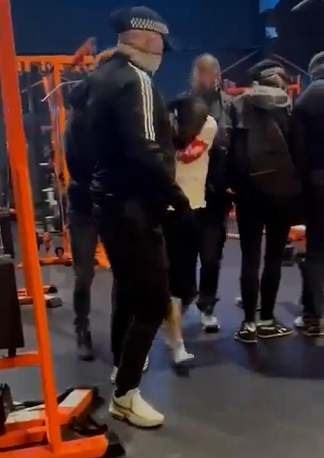 Dramatic moment ISIS-supporting migrant convicted over terror plot to gun down Jews is arrested by armed police as he works out in gym with son, 16