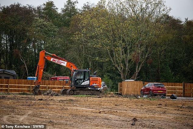 Travellers are ordered to leave illegal site opposite Britain's biggest nuclear weapons factory after building 13 static homes