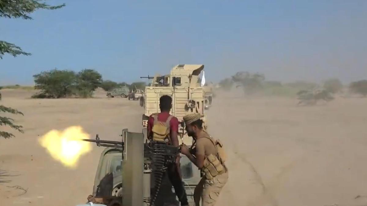 Yemeni government fighters recorded driving vehicles over Houthi opponents